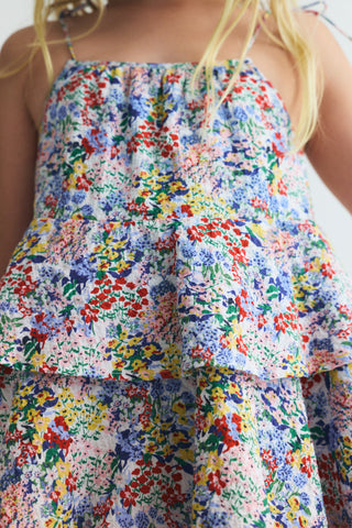 Detail of a 7 year old girl wearing the new society's Verbena Dress Verbena Print rented from a kids clothing rental subscription - Bundle to Bundle