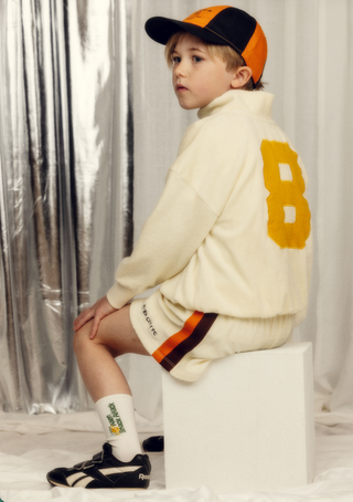 7 year old boy wearing FC half zip terry sweatshirt and Shorts from Mini Rodini rented on Bundle to Bundle
