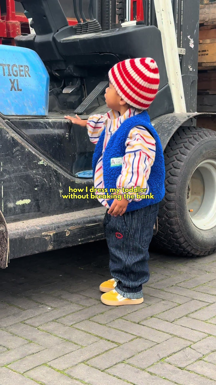 Celeste's toddler in a rented striped hat and vest