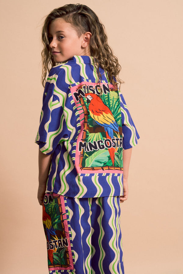 Back of 6 year old boy wearing Loros Wavy Shirt Blue from Maison Mangostan rented from Bundle to Bundle

